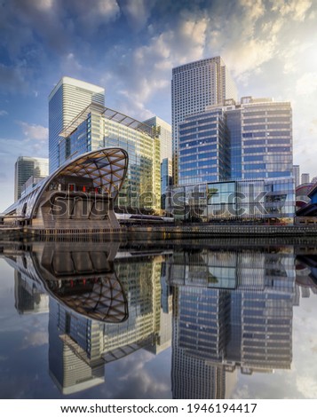 The modern skyscrapers of the financial district Canary Wharf in London, UK, on a sunny day with reflections in the water Royalty-Free Stock Photo #1946194417