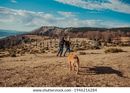 a young couple hiking having fun on the mountain