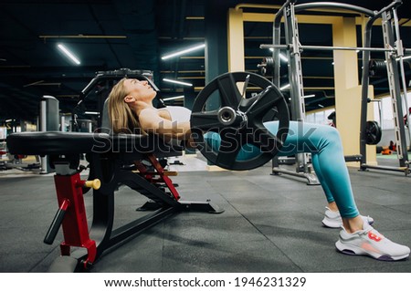 Fitness woman training with resistance workout exercise bands glute bridge with hip abduction at gym. Fit girl training with barbell Royalty-Free Stock Photo #1946231329