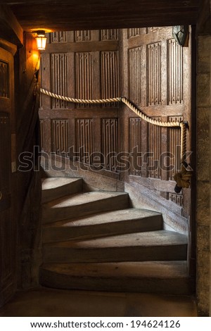 Wooden staircase in an old building Royalty-Free Stock Photo #194624126