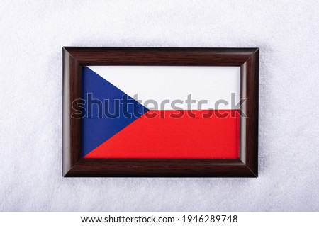 Czechia flag in a realistic frame on white cloth background flat lay photo