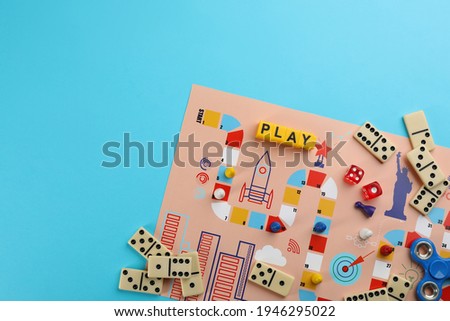 Components of board games on light blue background, flat lay. Space for text Royalty-Free Stock Photo #1946295022