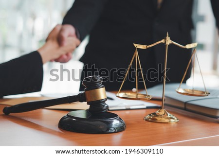 Businessman shaking hands to seal a deal with his partner

lawyers or attorneys discussing a contract agreement.Legal law, advice, and justice concept.