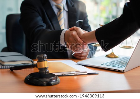 Businessman shaking hands to seal a deal with his partner
lawyers or attorneys discussing a contract agreement.Legal law, advice, and justice concept. Royalty-Free Stock Photo #1946309113