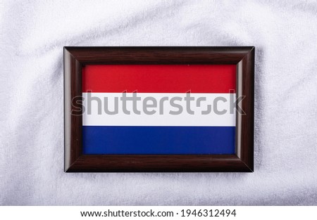 
Luxembourg flag in a realistic frame on white cloth background flat lay photo
