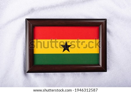 
Ghana flag in a realistic frame on white cloth background flat lay photo