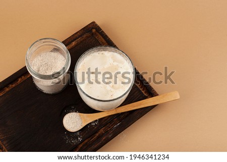 Misutgaru or Misugaru Latte on wooden serving board. Korean milkshake with roasted multi-grain powder. Popular breakfast drink. Healthy Protein smoothie. Royalty-Free Stock Photo #1946341234