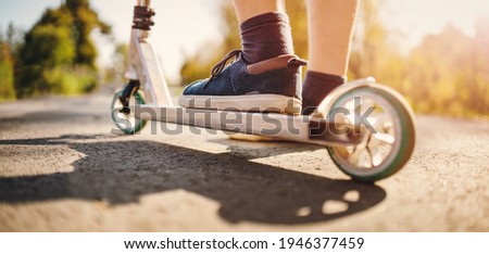 Cute children riding on bicycles on asphalt road in summer.