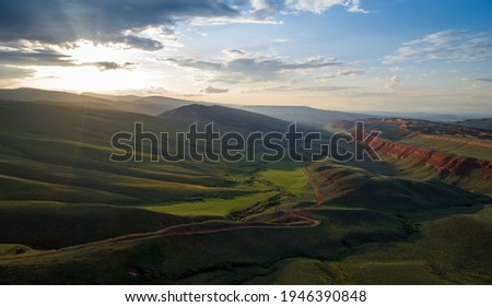 Beautiful red bluff with vibrant green valley