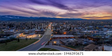 Drone shot with long shutter of small town with sunset.