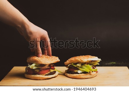 Preparing a homemade burger with fresh vegetables and beef