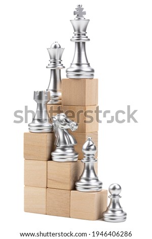 Hierarchy of chess pieces on step of wooden block; ranking of each piece sorted by pawn; bishop; knight; rook and queen respectively like as the promotion in career path