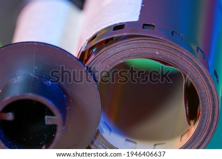 Analogue camera with Film on an colorful background photographed in the studio                             