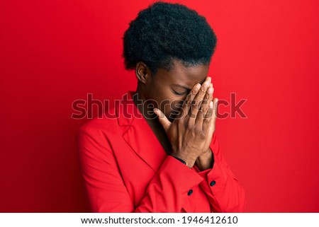 Young african american girl wearing business clothes with sad expression covering face with hands while crying. depression concept. 