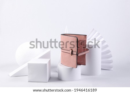 Leather purse and geometric shapes on white background. Minimalism, concept art