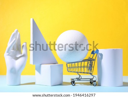 Concept art geometric composition of geometric shapes and shopping trolley on a blue yellow background. Minimalism. Sale. Showcase
