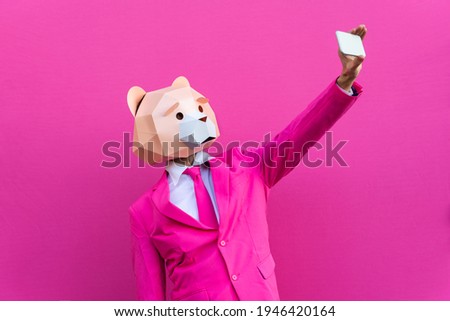 Happy man with funny low poly mask on colored background - Creative conceptual idea for advertising,adult with low-poly origami paper mask doing funny poses Royalty-Free Stock Photo #1946420164