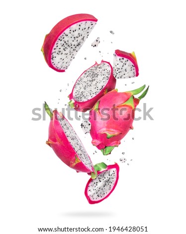 Sliced ripe dragon fruits (pitahaya) in the air, isolated on a white background