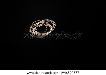 Light trails against a black sky outside. Shape of a circle. Artfull. Long exposure photo. Picture of the moon with a moving camera.