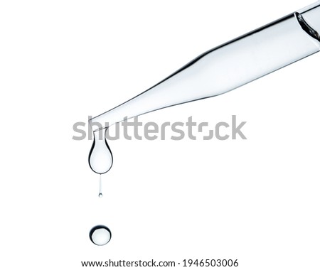 Pipette or Dropper with water drops. Concept for medicine, biology, cosmetic, pharmacy, perfume industry.  Laboratory test or experiment. Macro Clear glass on Isolated or transparent white background. Royalty-Free Stock Photo #1946503006