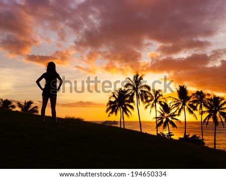 Woman enjoying nature sunset in Hawaii, USA. Enjoyment concept.