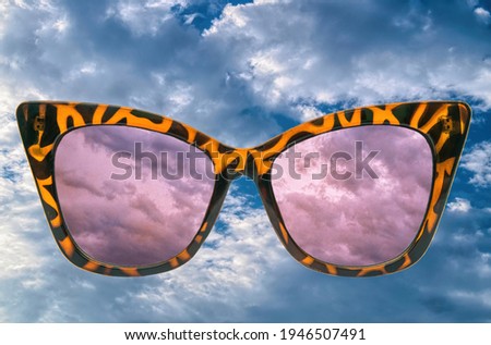 Illusion, dream and fantasy concept. Sunglasses and bright sky
