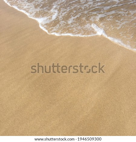 Picture of waves on the beach where the water slowly recedes so the waves look very small