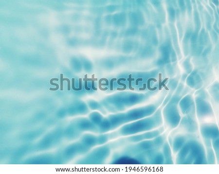 Closeup abstract of surface blue water for background. Blurred abstract for background. Water splash for background. Reflection on surface blue water in the sea.