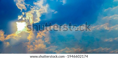 Natural sun flare with blue clouds sky and green leaves bring to be a beautiful background image