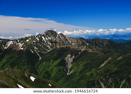 View of Mt.shiomi from the summit of Mt.notori in the Southern Alps,  minamiarupusu city, yamanashi prefecture, japan. Royalty-Free Stock Photo #1946616724