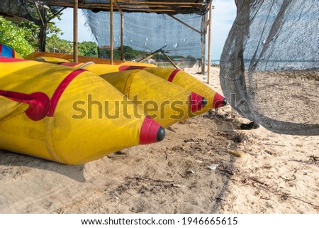 Banana boats are placed under the storage warehouse by the beach