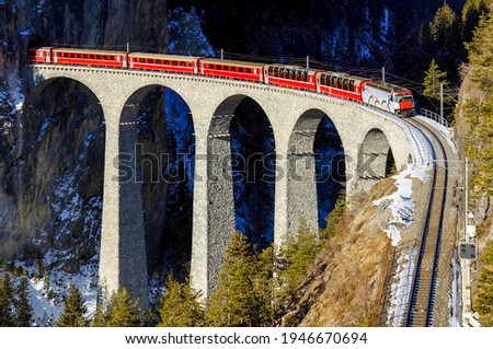 Train ride on mountain railroad bridge. Mountain railway bridge train ride. Railroad bridge in mountains Royalty-Free Stock Photo #1946670694