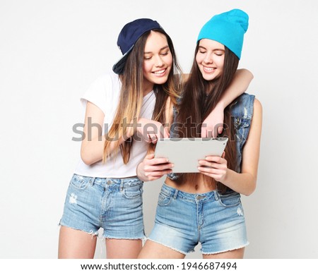 Two teenagers friends, hipster female, taking selfie with digital tablet