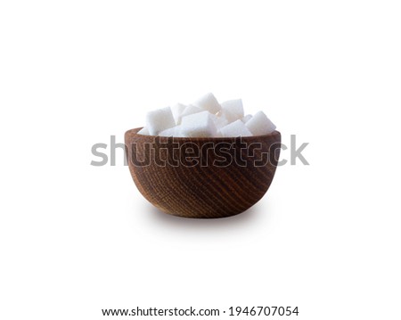 Sugar cube isolated on white. Selective focus. Sugar cube in wooden bowl on white background. Heap of sugar with copy space for text.  Royalty-Free Stock Photo #1946707054