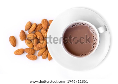 Glass of Almond coffee milk and almond nuts isolated on white. Healthy drinks concept.Top view. Flat lay.