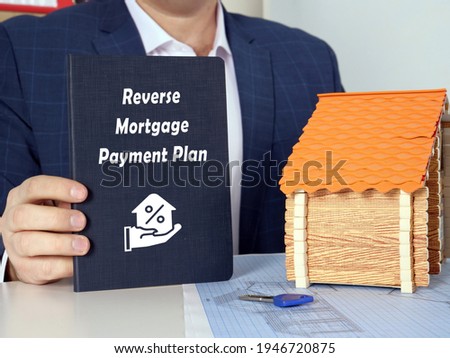  Reverse Mortgage Payment Plan inscription on dark blue book 
