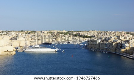 Panoramic view of Birgu city on the left and Senglea city on the right in the rays of sunset from Valletta fortress viewpoint. Birgu. Valletta. Malta.