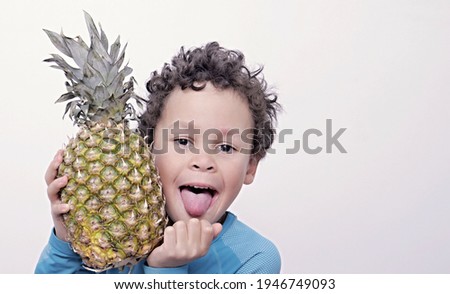 little boy holding a pineapple on white background stock image stock photo