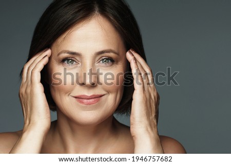 Portrait of a beautiful middle aged woman with clean wrinkled skin