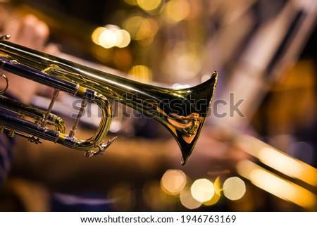  Fragment of the trumpet in the orchestra close-up in gold tones Royalty-Free Stock Photo #1946763169