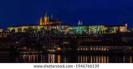 A picture of the Prague Castle complex taken from the other side of the Vltava river at night.