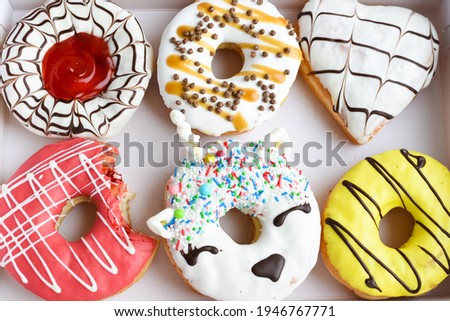 Assortment of decorated donuts with glaze. Doughnut box. Top view or flat lay.