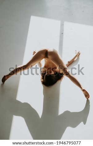 girl in panties with wide-spread legs on the floor
