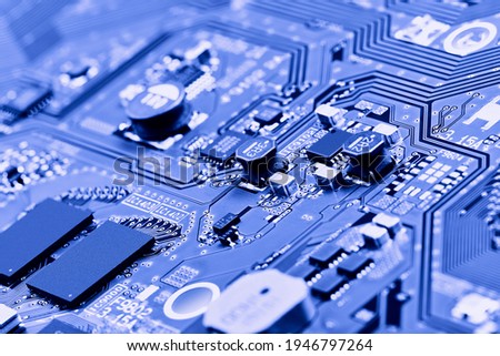 Electronic circuit board with electronic components such as chips close up. Blurry background
