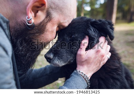 Man embracing his old sick dog. Man saying goodbuy to his old dying dog.
