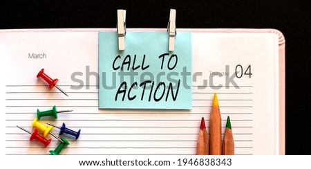 text Call To Action on stickers on diary with office tools