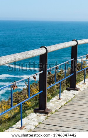Railing on the seashore, on the Paseo de Mataleñas in Santander, with padlocks hung by couples as a representation of love.