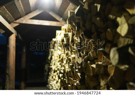 firewood in the woodpile. prepared fuel for kindling the stove in a country house. background texture of felled trees