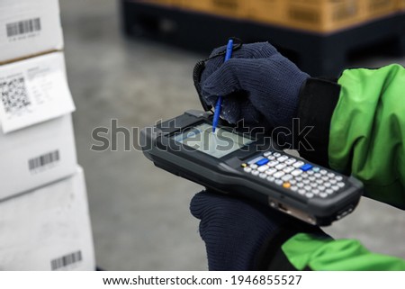 Bluetooth barcode scanner checking goods in the cold room or warehouse. Selection focus shooting on Bluetooth barcode scanner. Royalty-Free Stock Photo #1946855527