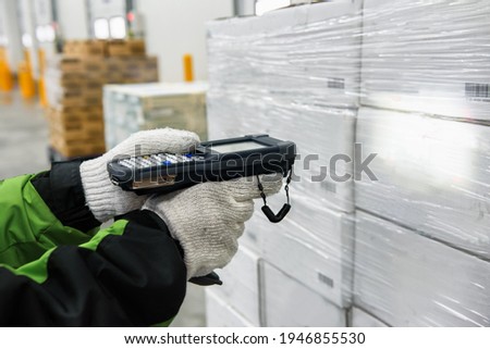 Bluetooth barcode scanner checking goods in the cold room or warehouse. Selection focus shooting on Bluetooth barcode scanner. Royalty-Free Stock Photo #1946855530